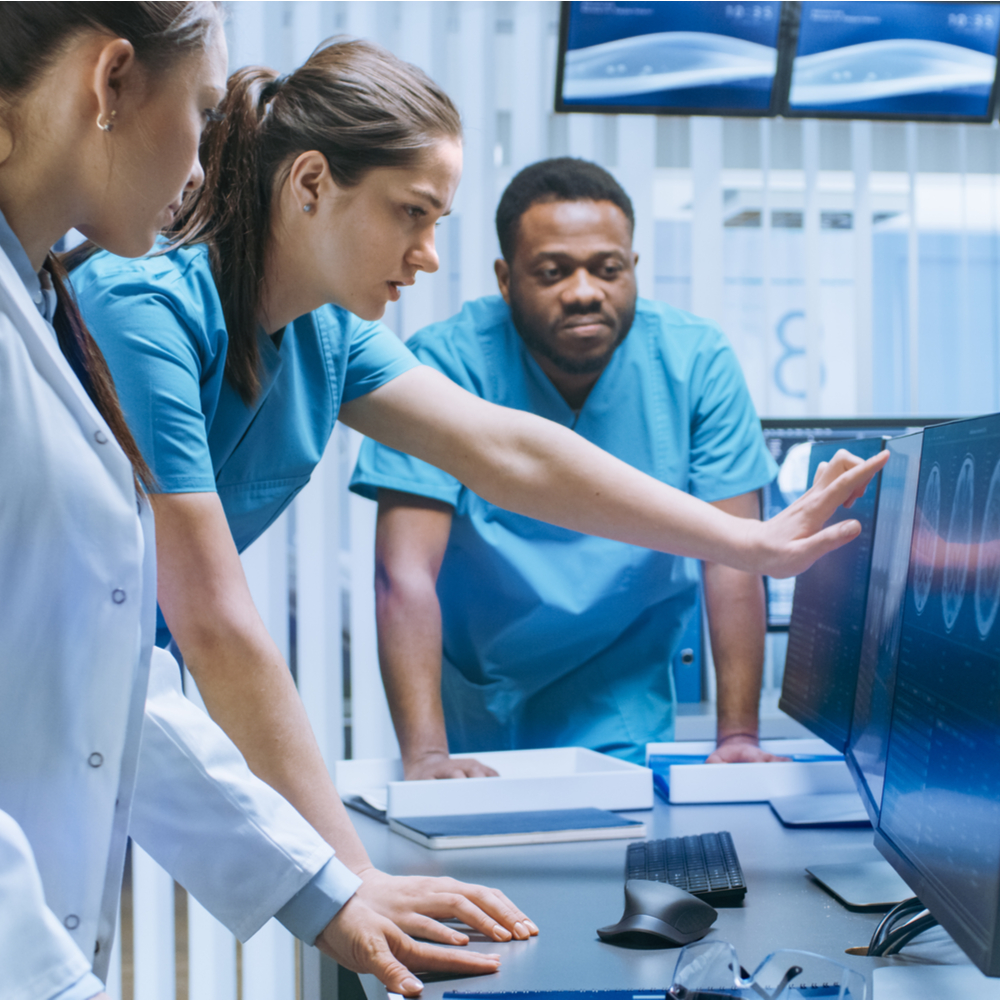 Radiology techs observing imaging results