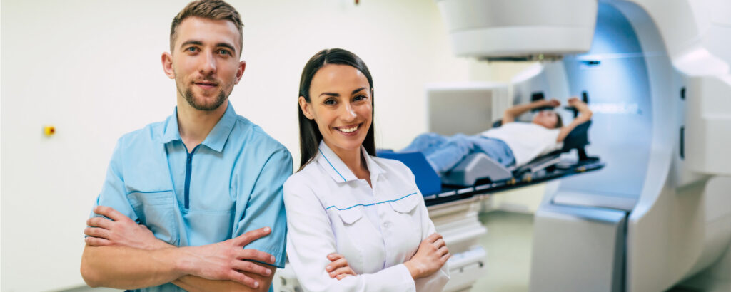Radiologic technologists in exam with patient